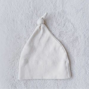 Colored organic newborn hat with top knot